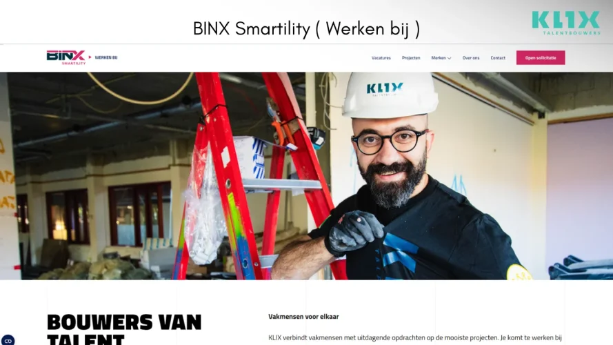 a man wearing a white hard hat and gloves